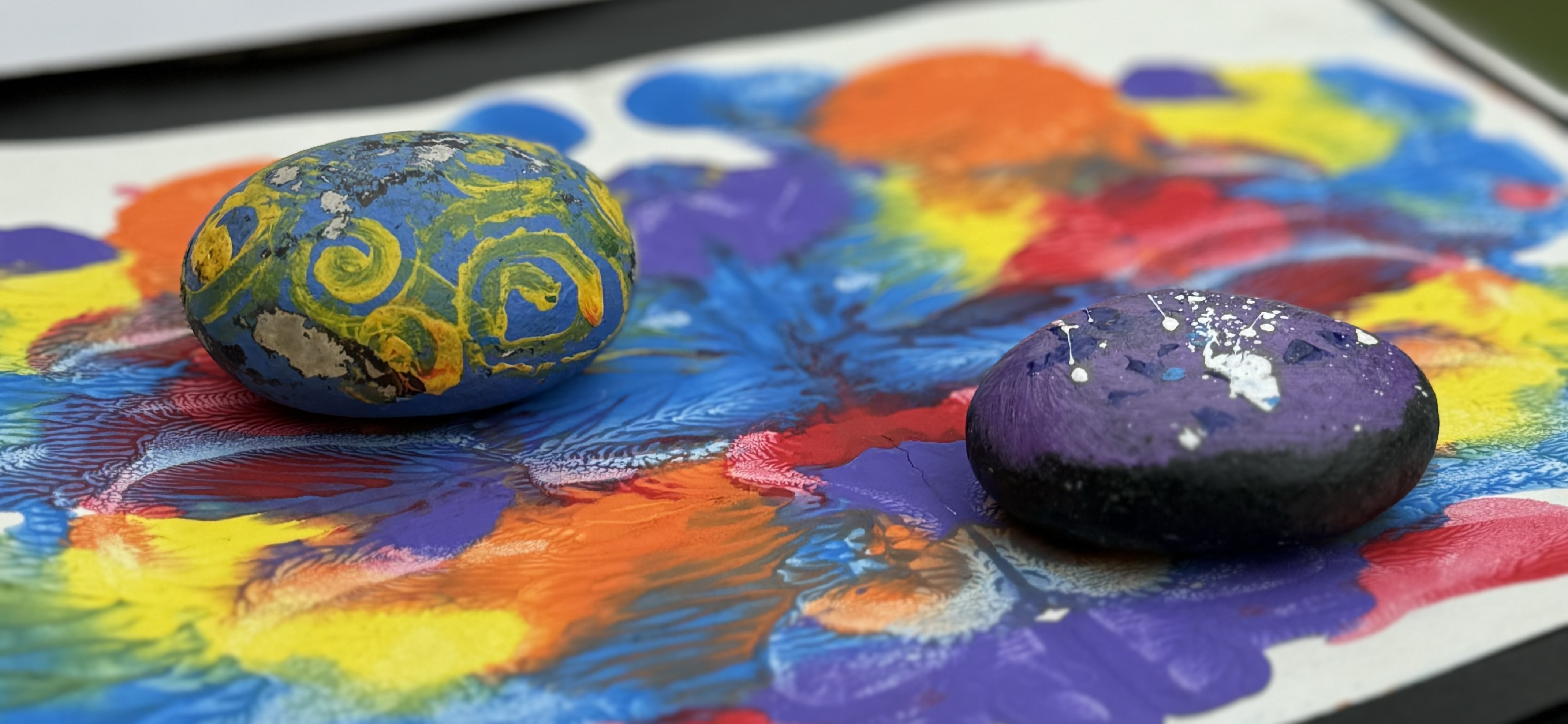 Children exploring paint materials at Kiva School